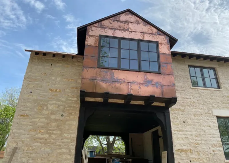 Copper metal panel facade on a stone building for Metal Roof Coating in Barbecue
