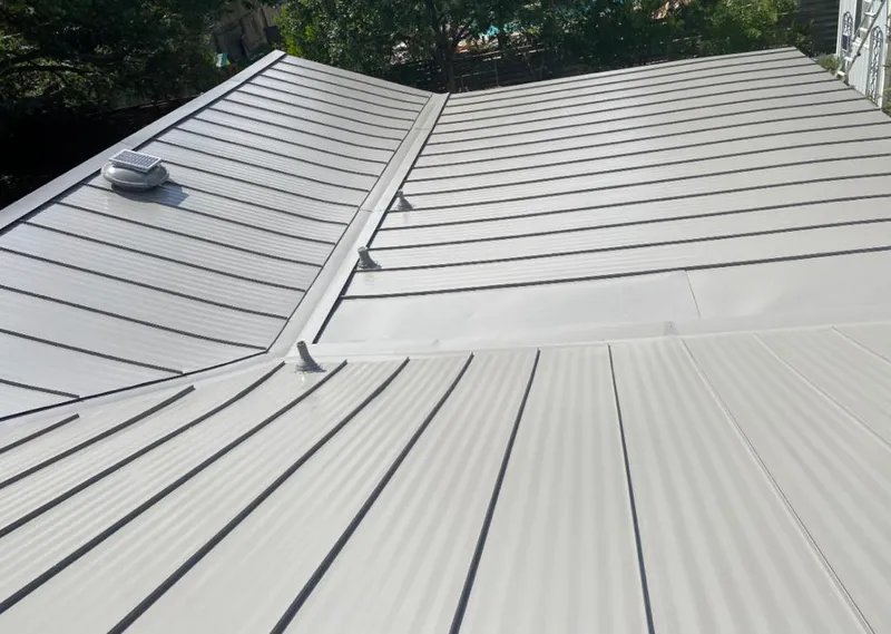 Solar attic fan installed on a metal roof for Roof Ventilation in Barbecue